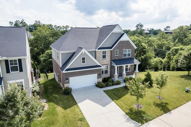 2320 Daybloom Ct, Hebron, KY 41048 - craftsman-style home with driveway, covered porch, a front yard, brick siding, and a shingled roof