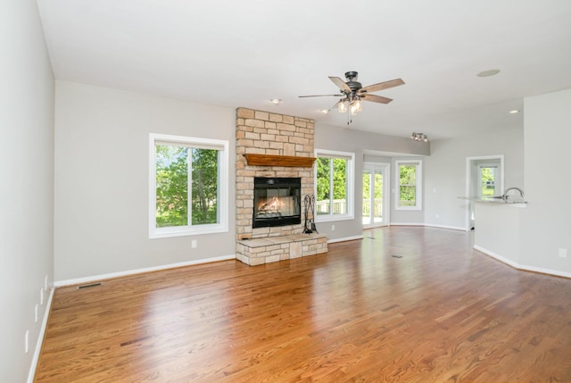 1169 Appomattox Dr, Florence, KY 41042 - unfurnished living room with a ceiling fan, wood finished floors, and a stone fireplace