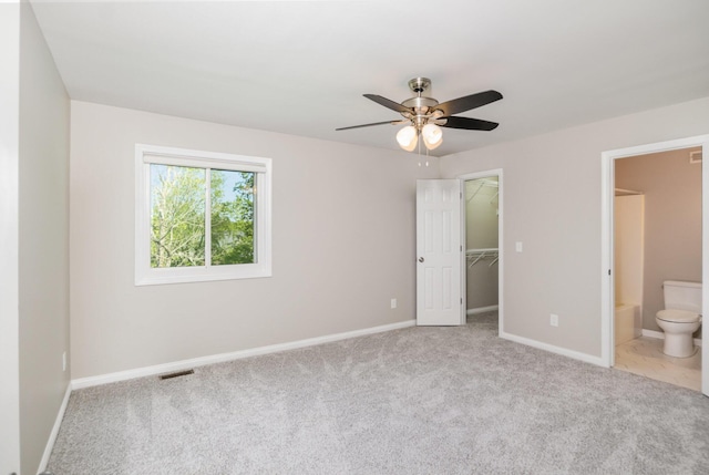 1169 Appomattox Dr, Florence, KY 41042 - unfurnished bedroom with carpet, a spacious closet, a closet, ceiling fan, and connected bathroom