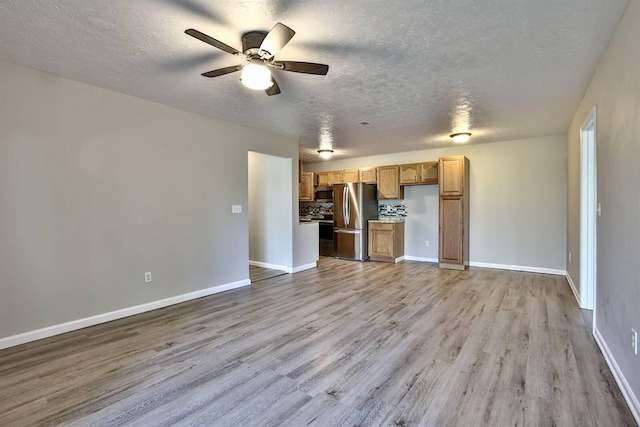 436 Marian Ln Unit 2, Florence, KY 41042 - unfurnished living room featuring a textured ceiling, ceiling fan, and light wood-type flooring