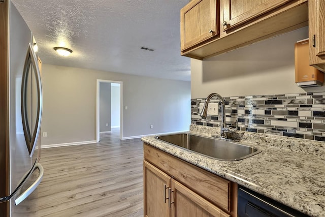 436 Marian Ln Unit 2, Florence, KY 41042 - kitchen featuring freestanding refrigerator, tasteful backsplash, dishwashing machine, light wood-style flooring, and a textured ceiling
