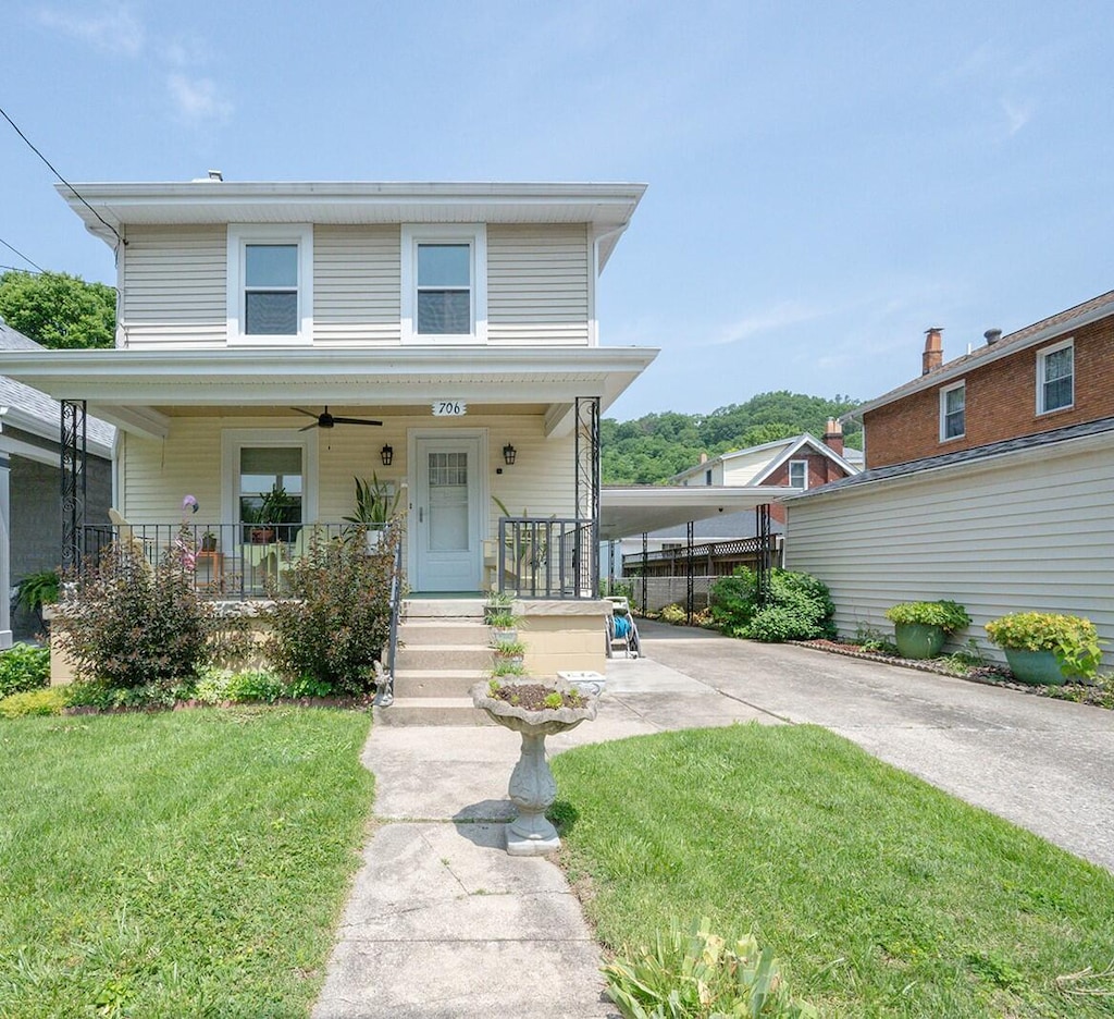 706 Hazel Ave, Latonia, KY 41015 - american foursquare style home featuring a front yard, concrete driveway, a porch, and a carport