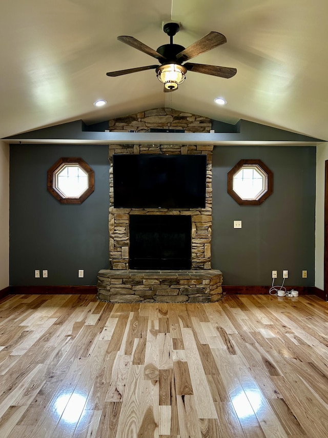 1756 Paxton Rd, Morning View, KY 41063 - unfurnished living room with a stone fireplace, ceiling fan, wood finished floors, vaulted ceiling, and plenty of natural light
