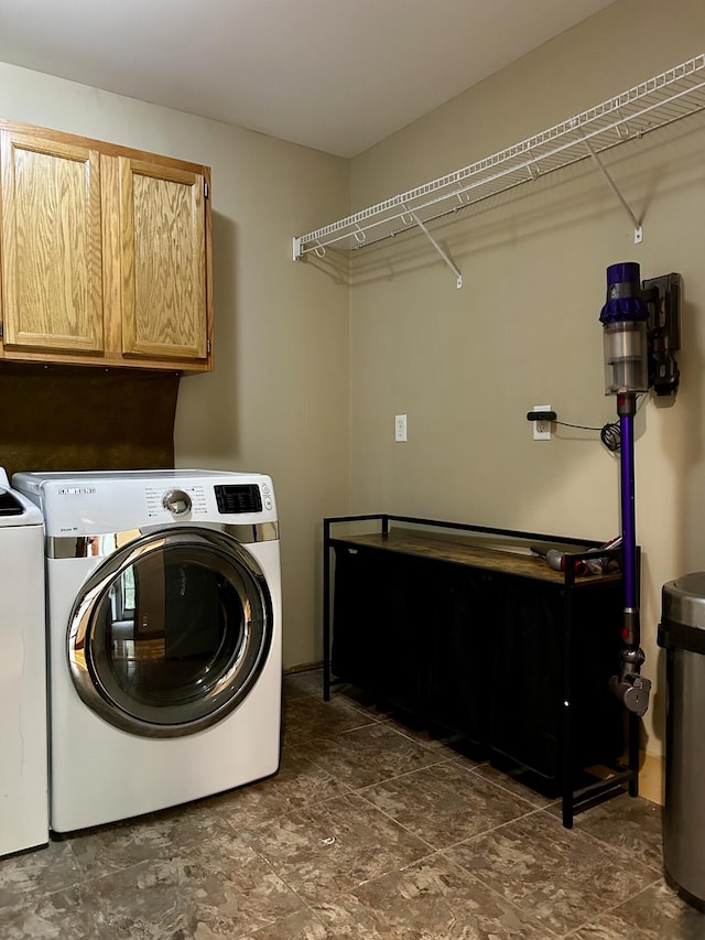 1756 Paxton Rd, Morning View, KY 41063 - laundry room featuring washing machine and dryer, cabinet space, and dark stone finish flooring