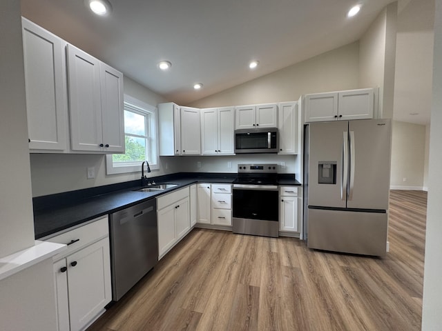 170 Saddlebrook Ln, Dry Ridge, KY 41035 - kitchen featuring appliances with stainless steel finishes, light wood-style floors, vaulted ceiling, dark countertops, and recessed lighting