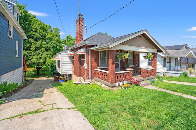 377 Linden Ave, Southgate, KY 41071 - bungalow-style home with a porch, brick siding, driveway, a chimney, and a front yard