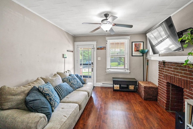 377 Linden Ave, Southgate, KY 41071 - living room featuring wood finished floors, ceiling fan, a brick fireplace, a baseboard radiator, and ornamental molding