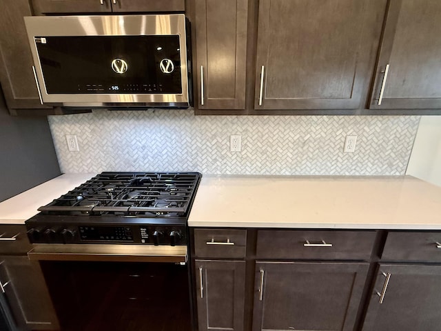 10448 Pleaasant Ridge Rd, Alexandria, KY 41001 - kitchen featuring stainless steel microwave, black gas range oven, dark brown cabinetry, light countertops, and decorative backsplash