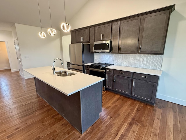 10448 Pleaasant Ridge Rd, Alexandria, KY 41001 - kitchen with stainless steel appliances, decorative backsplash, an island with sink, dark wood-type flooring, and high vaulted ceiling