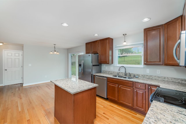 9513 Old Union Rd, Union, KY 41091 - kitchen with appliances with stainless steel finishes, a kitchen island, light wood-type flooring, pendant lighting, and recessed lighting