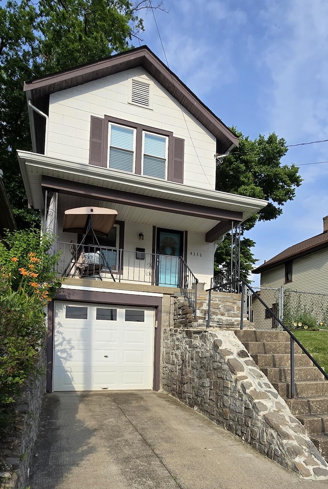 4336 Glenn Ave, Covington, KY 41015 - view of front of house featuring a porch, stairway, an attached garage, and concrete driveway