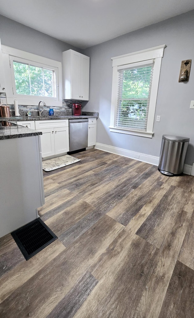 4336 Glenn Ave, Covington, KY 41015 - kitchen featuring stainless steel dishwasher, white cabinets, dark wood finished floors, dark stone counters, and decorative backsplash