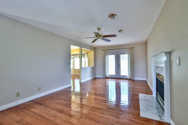 1906 Robins Run, Hebron, KY 41048 - unfurnished living room with french doors, a ceiling fan, a premium fireplace, and wood finished floors
