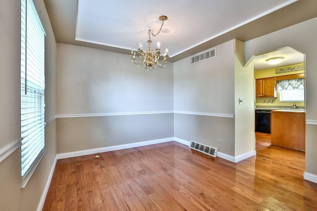 1906 Robins Run, Hebron, KY 41048 - spare room featuring a chandelier, light wood finished floors, and arched walkways
