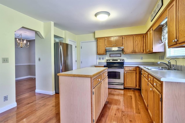 1906 Robins Run, Hebron, KY 41048 - kitchen with appliances with stainless steel finishes, light countertops, light wood finished floors, and a chandelier