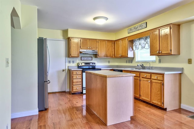 1906 Robins Run, Hebron, KY 41048 - kitchen with appliances with stainless steel finishes, under cabinet range hood, light countertops, light wood-style flooring, and a kitchen island