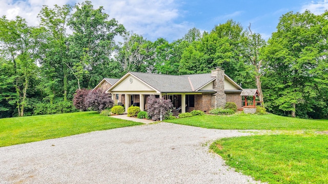12998 Shaw Goetz Rd, California, KY 41007 - view of front facade featuring a chimney, a front lawn, driveway, and covered porch