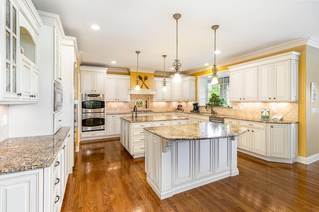 1007 Campo Ct, Union, KY 41091 - kitchen with an island with sink, appliances with stainless steel finishes, dark wood-style flooring, backsplash, and recessed lighting