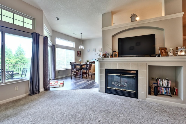 852 Flint Rdg Unit 4-302, Cold Spring, KY 41076 - living area with carpet floors, a textured ceiling, and a tile fireplace