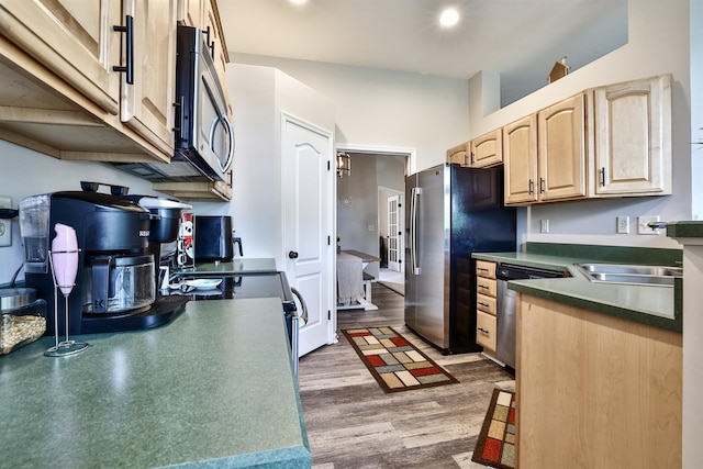 852 Flint Rdg Unit 4-302, Cold Spring, KY 41076 - kitchen with light brown cabinetry, stainless steel appliances, dark countertops, and wood finished floors