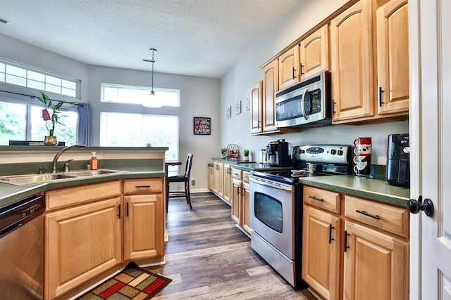852 Flint Rdg Unit 4-302, Cold Spring, KY 41076 - kitchen featuring stainless steel appliances, dark countertops, dark wood finished floors, a textured ceiling, and light brown cabinetry