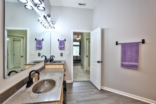 852 Flint Rdg Unit 4-302, Cold Spring, KY 41076 - ensuite bathroom featuring double vanity, wood finished floors, and a towering ceiling