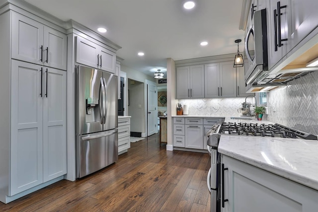 328 Creekwood Dr, Edgewood, KY 41017 - kitchen with appliances with stainless steel finishes, decorative backsplash, dark wood-style flooring, light stone countertops, and recessed lighting