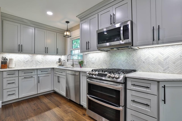 328 Creekwood Dr, Edgewood, KY 41017 - kitchen with stainless steel appliances, decorative backsplash, gray cabinetry, light stone counters, and dark wood-style flooring