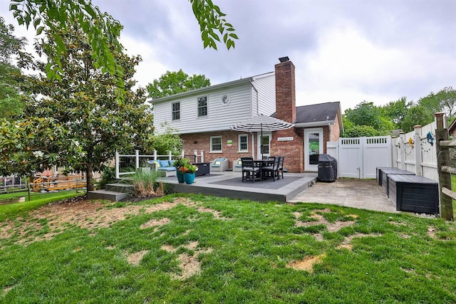 328 Creekwood Dr, Edgewood, KY 41017 - back of property with a fenced backyard, brick siding, a chimney, a patio area, and an outdoor hangout area