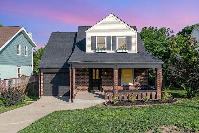 7 Ross Ave, Fort Mitchell, KY 41017 - view of front facade featuring covered porch, an attached garage, brick siding, concrete driveway, and a yard