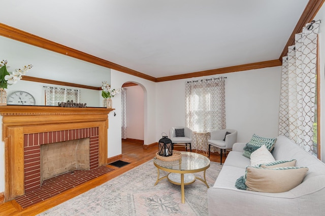 7 Ross Ave, Fort Mitchell, KY 41017 - living room with crown molding, arched walkways, wood finished floors, and a fireplace