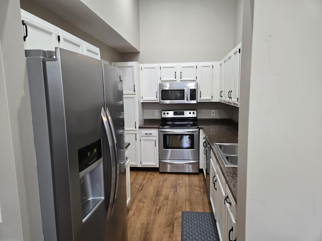 10 Meadow Ln Unit 9, Highland Heights, KY 41076 - kitchen featuring stainless steel appliances, dark wood-type flooring, and white cabinets