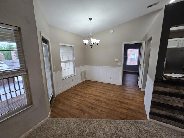 10 Meadow Ln Unit 9, Highland Heights, KY 41076 - unfurnished dining area featuring a chandelier, lofted ceiling, wainscoting, dark wood-style floors, and a decorative wall
