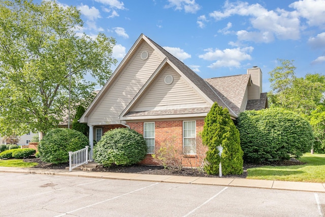 10602 Christa Ct Unit 6, Alexandria, KY 41001 - view of front facade with brick siding, a chimney, a shingled roof, and uncovered parking
