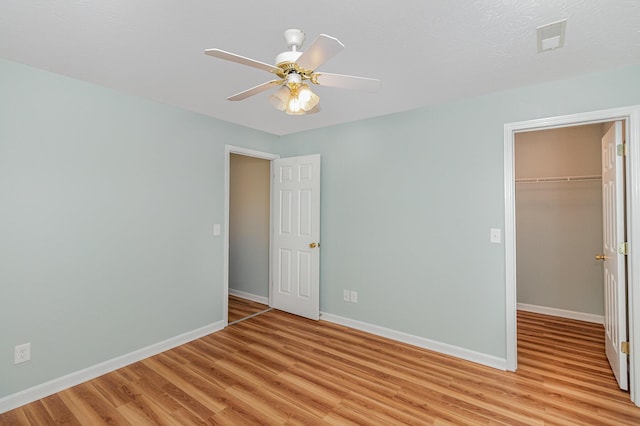 10602 Christa Ct Unit 6, Alexandria, KY 41001 - unfurnished bedroom featuring light wood finished floors, a closet, a spacious closet, and a ceiling fan
