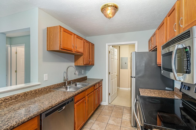 10602 Christa Ct Unit 6, Alexandria, KY 41001 - kitchen with stainless steel appliances, dark countertops, brown cabinetry, light tile patterned flooring, and a textured ceiling
