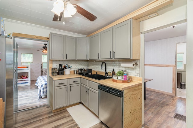 9294 Marshall Rd, Covington, KY 41015 - kitchen with appliances with stainless steel finishes, ceiling fan, gray cabinets, light wood finished floors, and a wainscoted wall