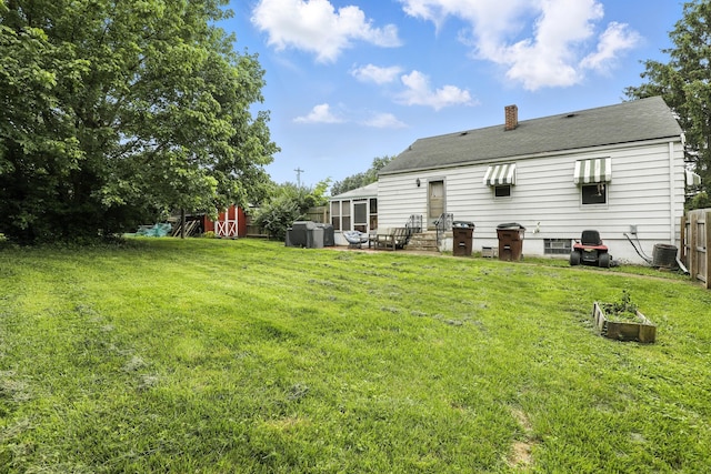 50 Russell St, Florence, KY 41042 - back of house featuring a chimney, roof with shingles, and a patio area