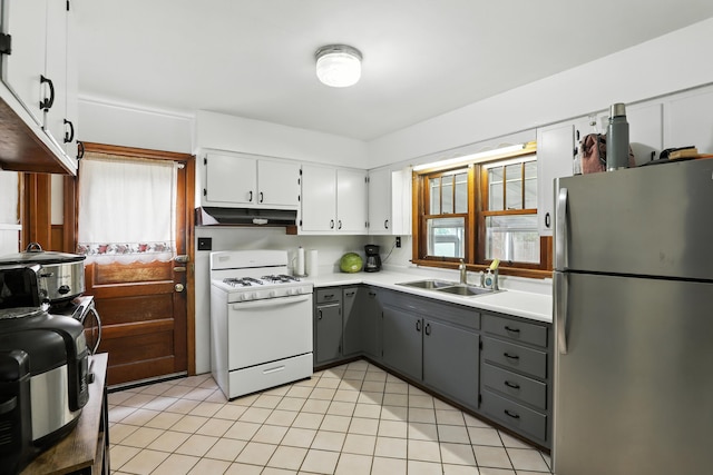 50 Russell St, Florence, KY 41042 - kitchen with freestanding refrigerator, white gas range, under cabinet range hood, gray cabinets, and light countertops
