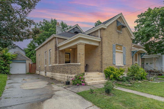 3712 Park Ave, Covington, KY 41015 - view of front of home with brick siding, asphalt driveway, a chimney, a porch, and an outdoor structure