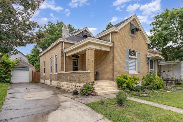 3712 Park Ave, Covington, KY 41015 - view of front of property featuring brick siding, a chimney, concrete driveway, an outdoor structure, and a detached garage