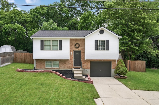 1212 Leslie Marie Ct, Elsmere, KY 41018 - raised ranch featuring an attached garage, driveway, brick siding, and view of scattered trees