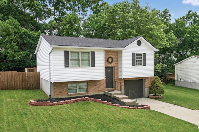 1212 Leslie Marie Ct, Elsmere, KY 41018 - raised ranch featuring a garage, driveway, brick siding, and a shingled roof