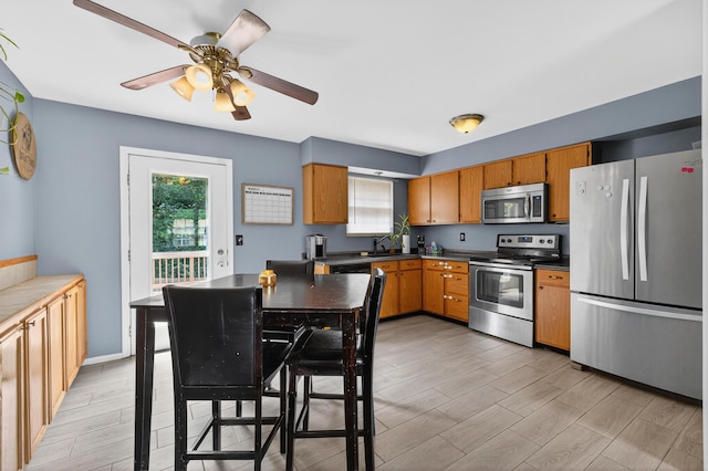1212 Leslie Marie Ct, Elsmere, KY 41018 - kitchen featuring appliances with stainless steel finishes, plenty of natural light, a ceiling fan, and light wood-style floors