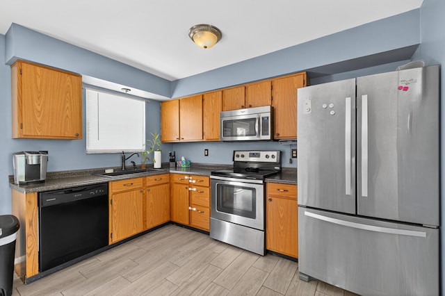 1212 Leslie Marie Ct, Elsmere, KY 41018 - kitchen with appliances with stainless steel finishes, dark countertops, light wood-style floors, and brown cabinets