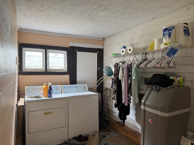 3057 Front St, Petersburg, KY 41080 - laundry area with separate washer and dryer, wood walls, and a textured ceiling