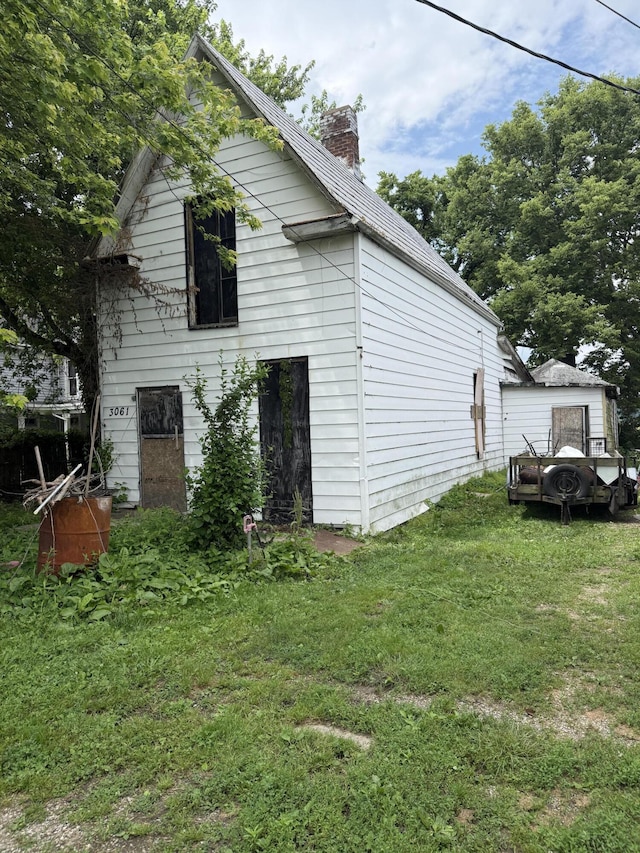 3057 Front St, Petersburg, KY 41080 - view of side of home featuring a chimney and a lawn
