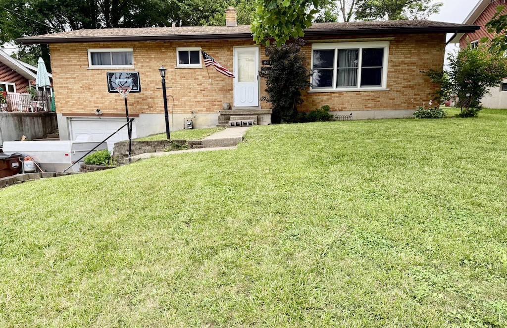 444 Mcalpin Ave, Erlanger, KY 41018 - view of front of property featuring an attached garage, brick siding, a front lawn, and a chimney