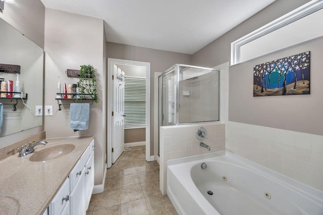 9128 Belvedere Ct, Florence, KY 41042 - bathroom featuring vanity, a stall shower, a jetted tub, and tile patterned flooring