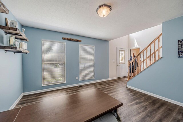 9128 Belvedere Ct, Florence, KY 41042 - foyer entrance with stairway, wood finished floors, and a textured ceiling